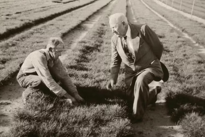 Hugh Hammond Bennet, right, the first head of the Soil Conservation Service, speaks with a farmer in his field.